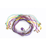 Pack de sept bracelets porte-bonheur avec les pierres quartz rose, améthyste, grenat, oeil du tigre, tourmaline, calcédoine bleue, cristal de roche.